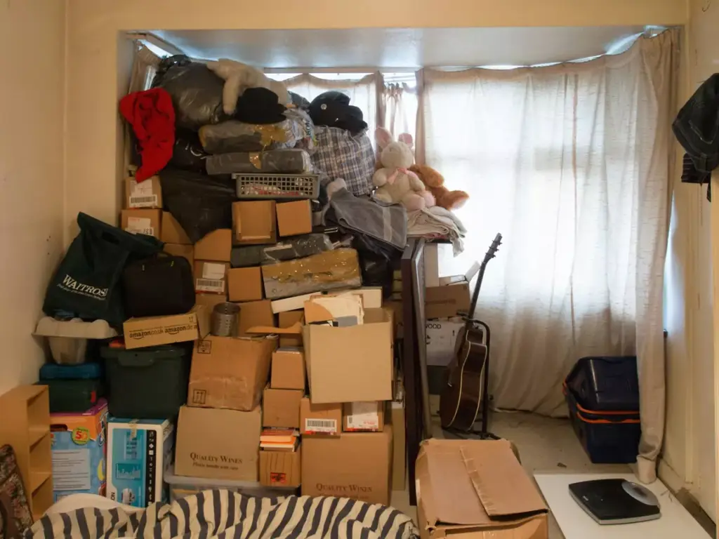 Hoarder house clearance, showing room cluttered with rubbish